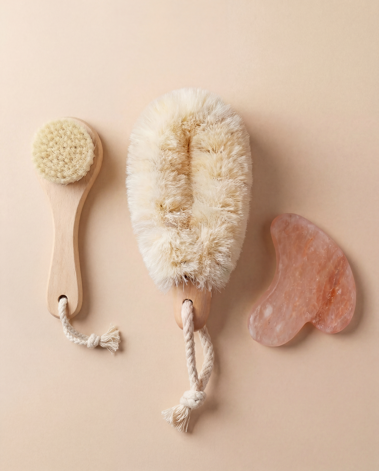 Three natural skin care tools for detoxification on a beige background