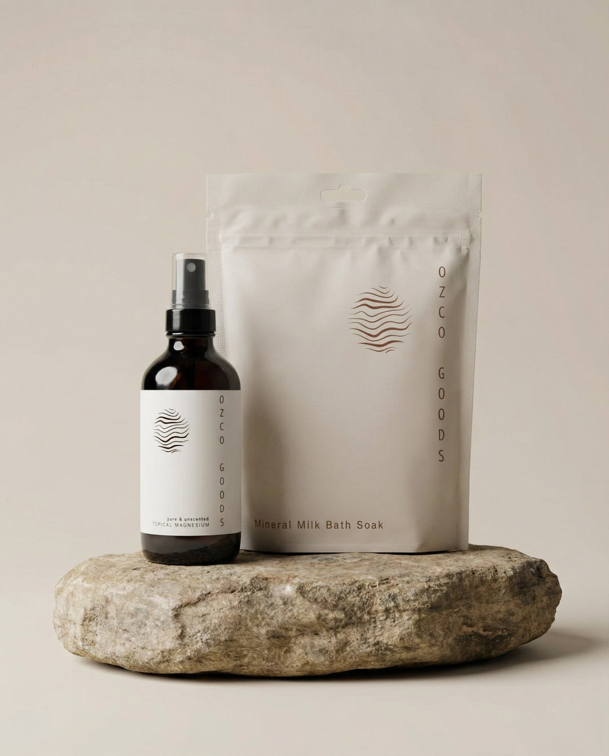 Unscented Magnesium Spray and OZCO Goods Bath Soak on a stone surface with a neutral background